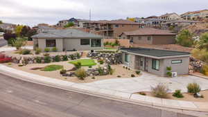 View of front of home featuring a putting area, a residential view, stucco siding, and stone siding