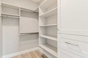 Walk in closet featuring light wood-type flooring
