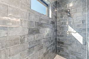 Bathroom featuring a tile shower