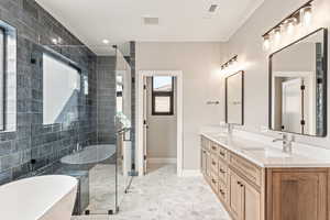 Full bathroom featuring double vanity, a stall shower, a soaking tub, tile walls, and recessed lighting