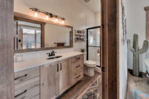 Full bath featuring polished Quartz countertop, copper undermount sink and tiled walk-in shower