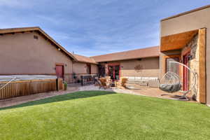 Back Courtyard with outdoor living space, bar seating,  a hot tub, and patio area around the fire pit