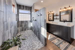Large walk-in shower featuring multiple body sprays, rain head and handheld sprayer
