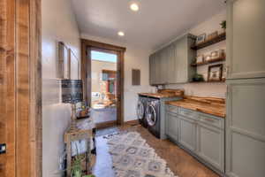 Laundry room featuring cabinet storage, shelves and butcherblock folding counter