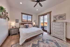 Primary Bedroom featuring access to exterior, a ceiling fan, and multiple windows