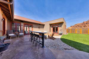 Enclosed courtyard with stained, stamped pathways and rusted metal privacy fence
