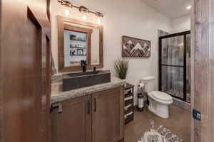 Full bathroom featuring honed marble vanity and stone and tile shower