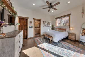 Bedroom featuring ensuite bath, recessed lighting, and ceiling fan