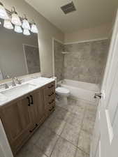 Upstairs Full bath featuring vanity, shower / tub combination, and light tile patterned floors