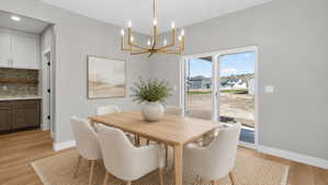 Dining area featuring a contemporary gold-tone chandelier