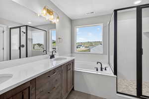 Full bathroom with a shower stall, double vanity, a bath, light tile patterned flooring, and recessed lighting