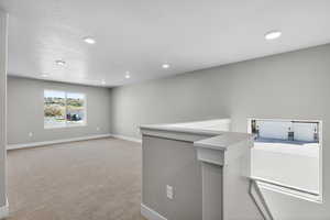 Unfurnished room with light carpet and recessed lighting