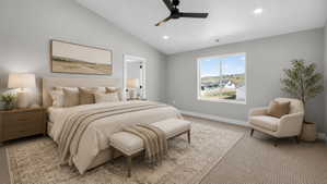 Vaulted ceilings enhance this spacious bedroom, featuring a large window, recessed lighting, a ceiling fan, and carpet flooring