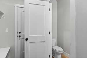 Bathroom with toilet and light wood-type flooring