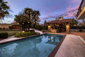 Outdoor pool featuring a patio, a fenced backyard, and a water slide