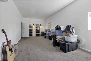 Interior space featuring light carpet and baseboards