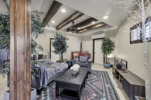 Living room featuring beam ceiling, recessed lighting, and a ceiling fan