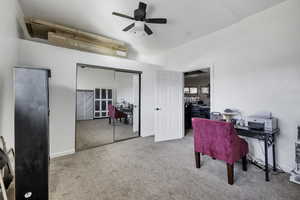 Office space featuring a ceiling fan and light carpet