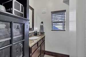 Bathroom featuring vanity and baseboards