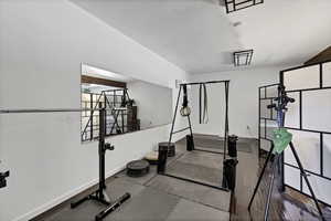 Workout room featuring hardwood / wood-style floors and baseboards