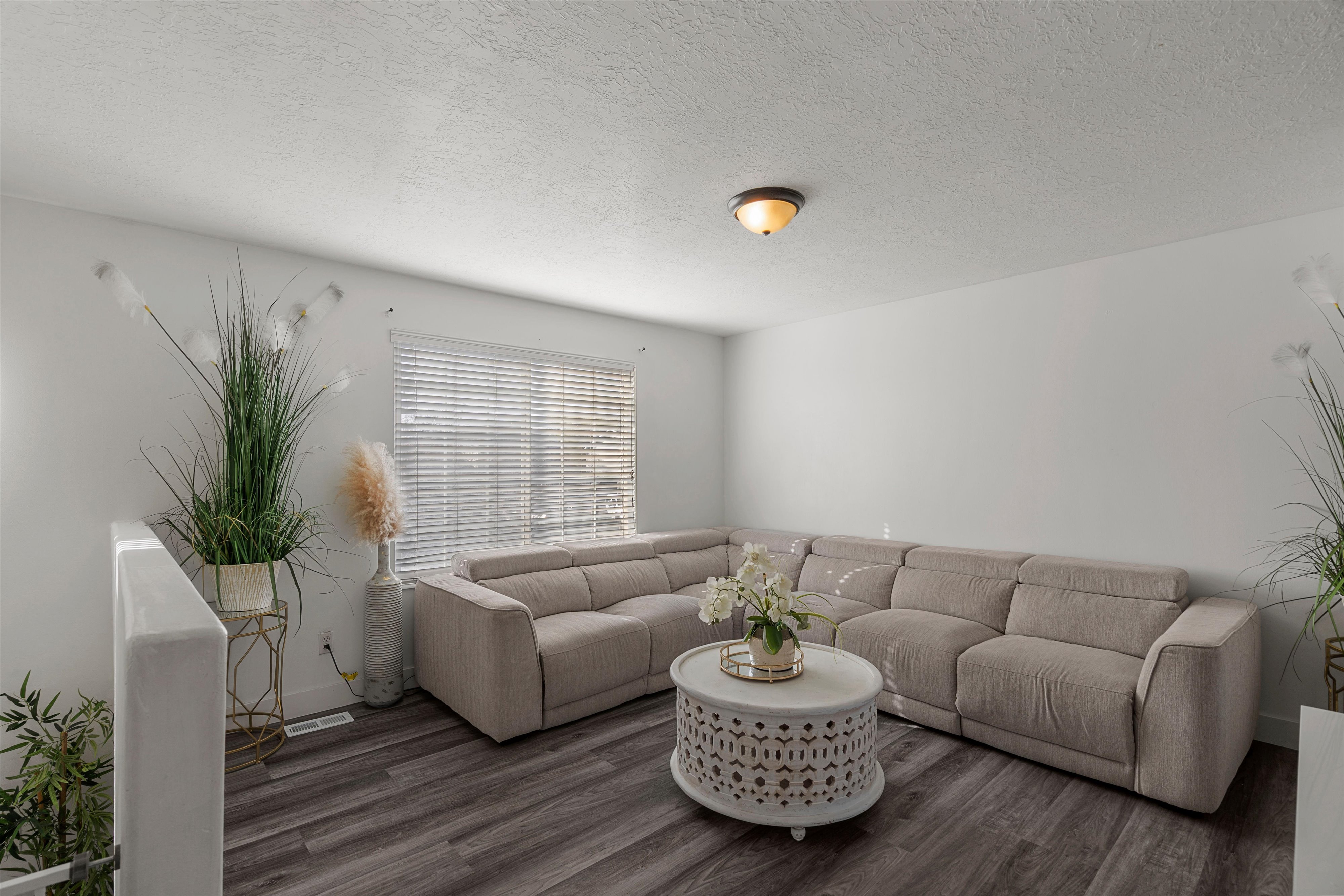 Living area featuring a textured ceiling and wood finished floors