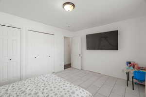 Bedroom with two closets and baseboards
