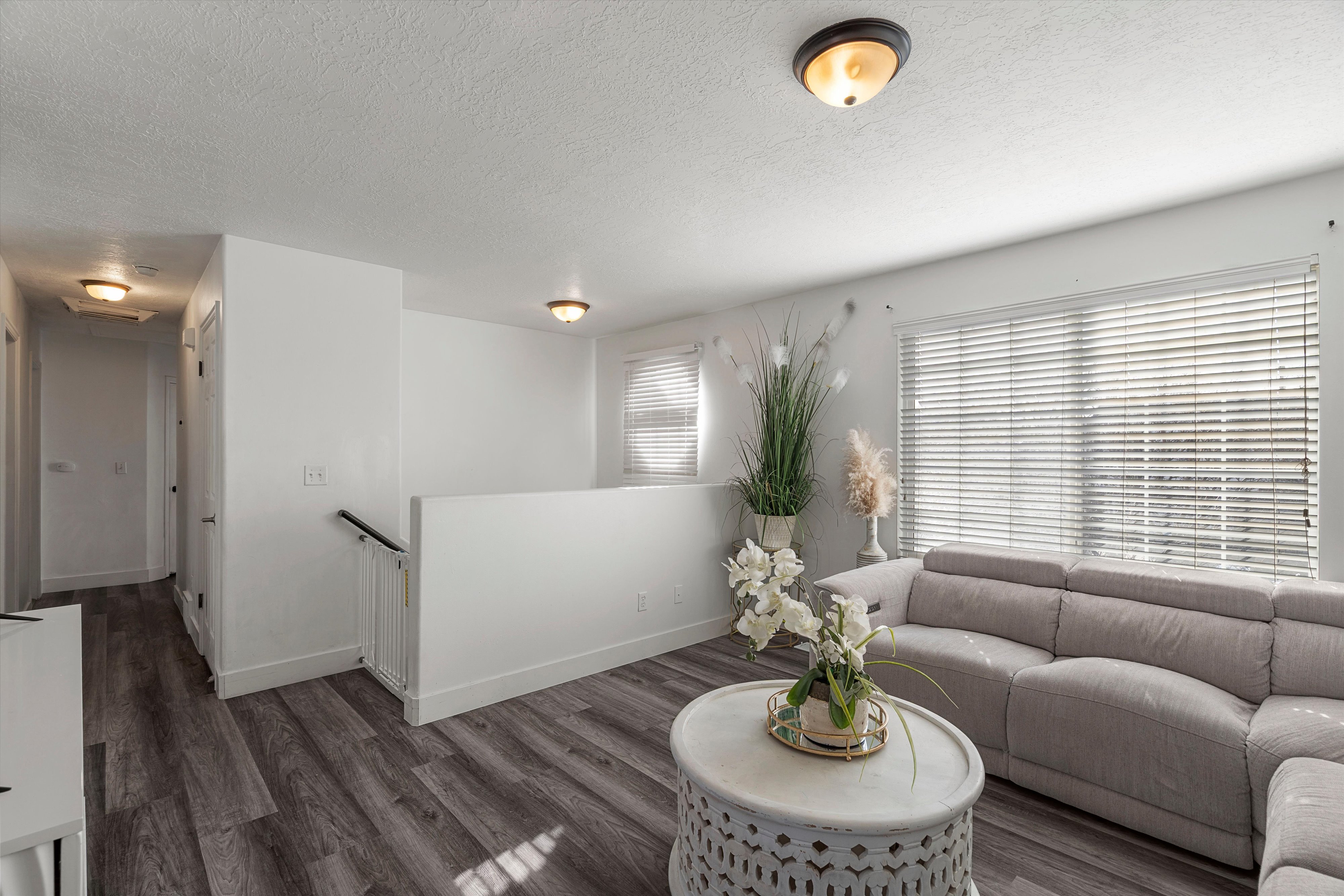 Living room with wood finished floors and a textured ceiling