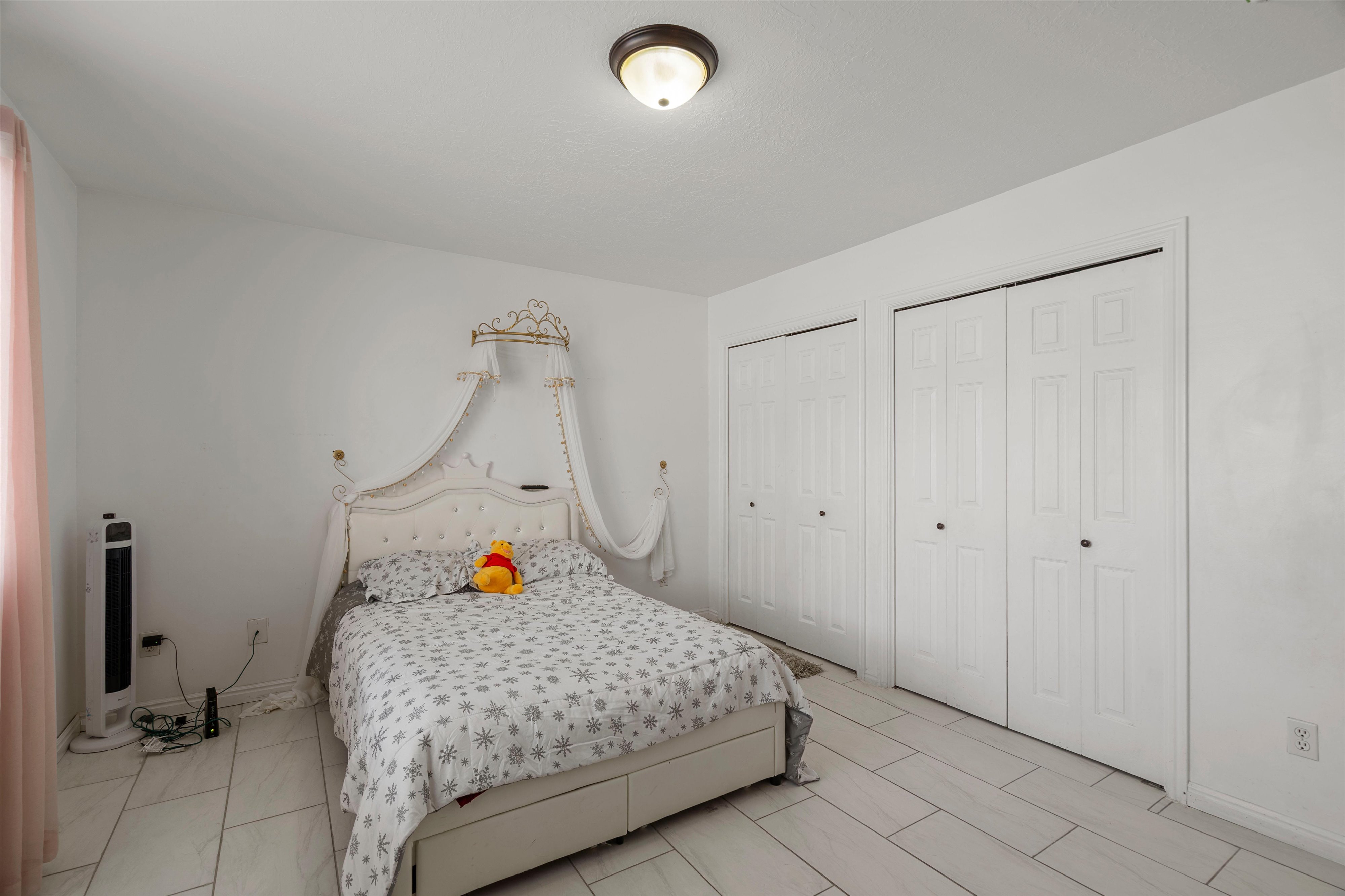 Bedroom featuring multiple closets and baseboards