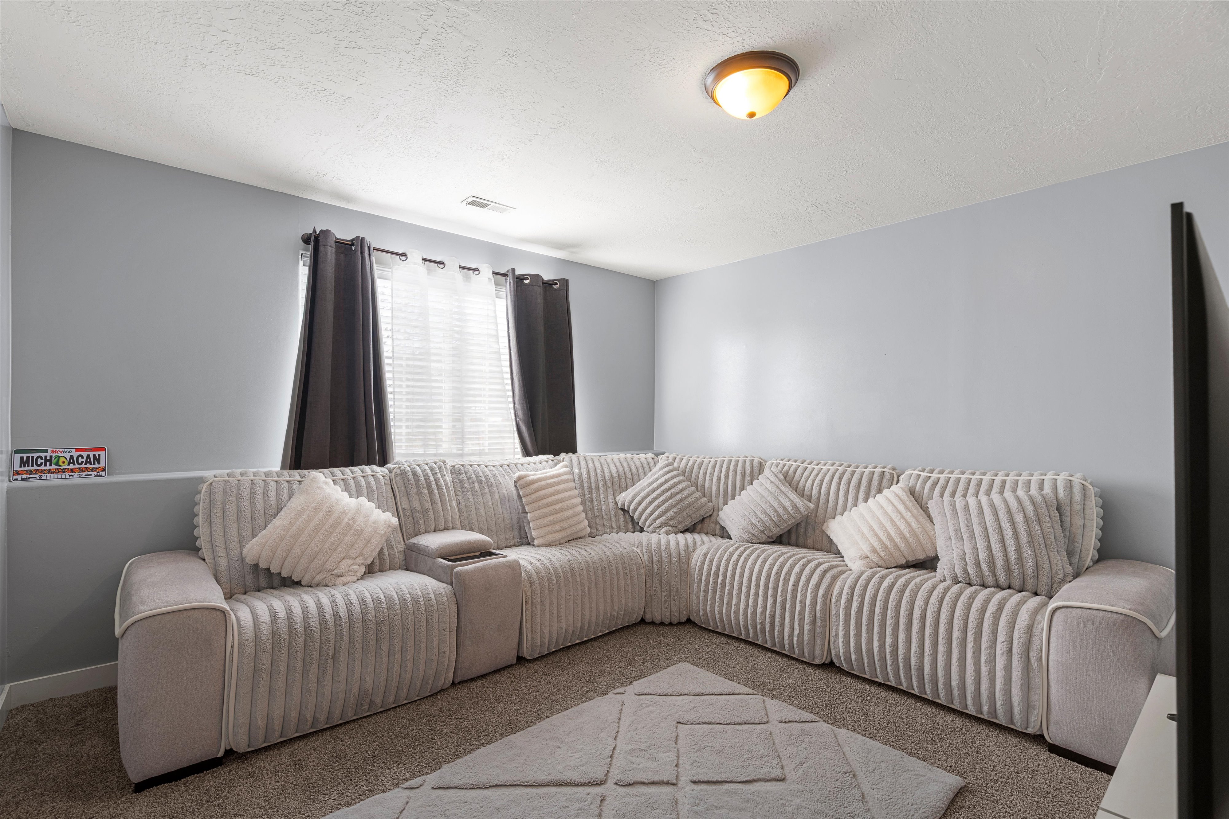 Carpeted living room featuring a textured ceiling
