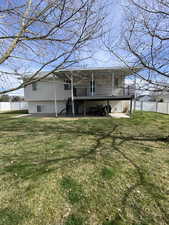 Rear view of property featuring a deck and a patio