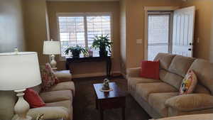 Living room with carpet floors and baseboards
