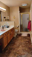 Bathroom with vanity and a shower stall