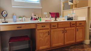 Full bath featuring vanity and dark tile patterned flooring