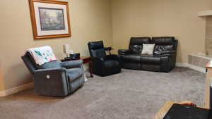 Carpeted living area with baseboards