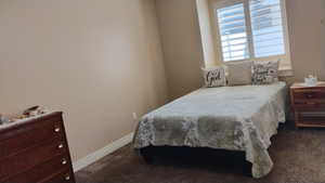 Bedroom featuring dark carpet