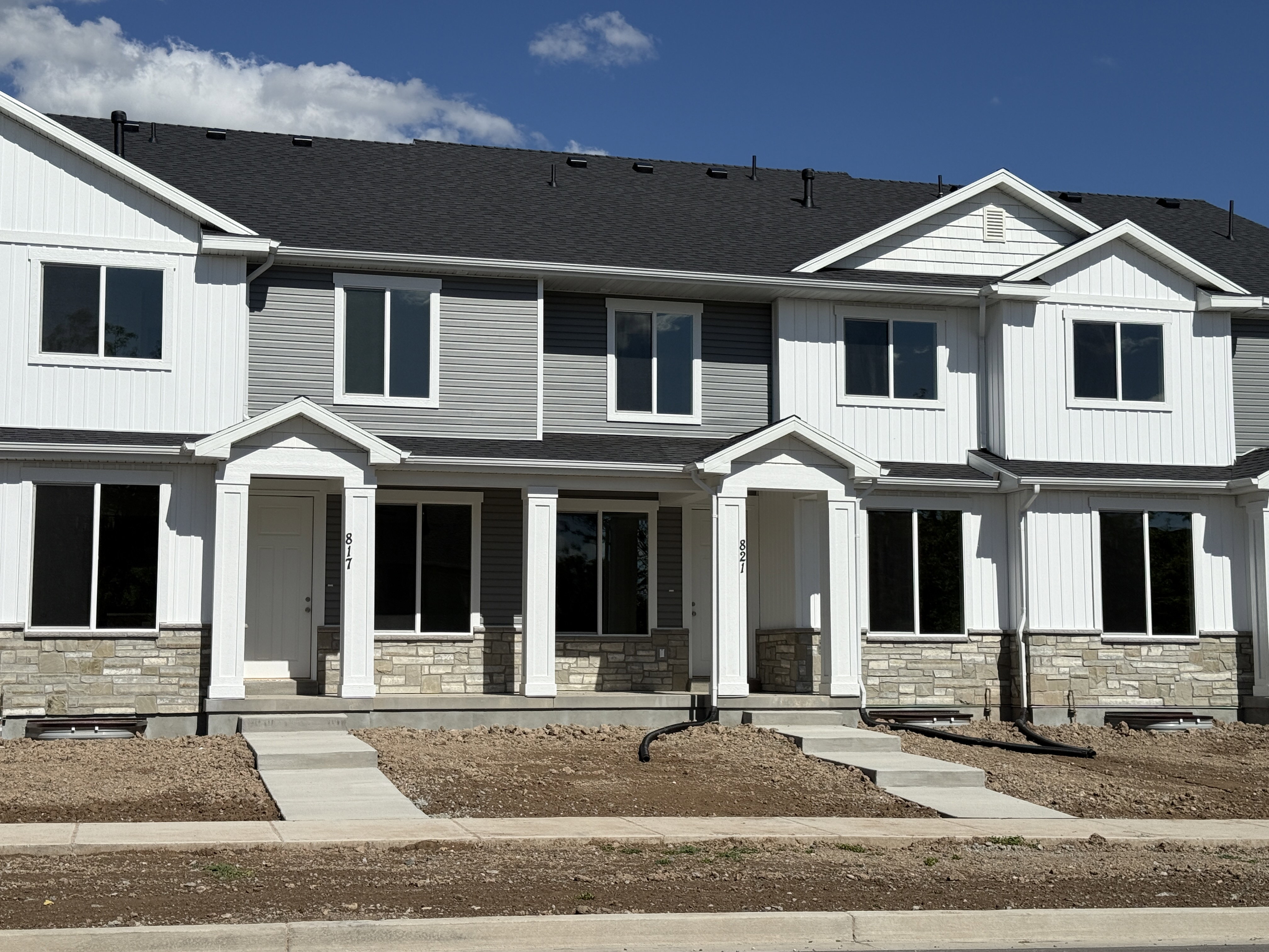 Contemporary townhome exterior featuring a combination of horizontal siding and vertical paneling