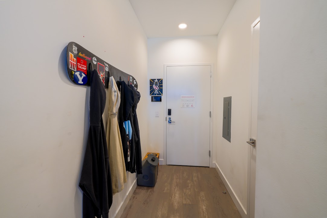 Doorway with wood finished floors, recessed lighting, and electric panel