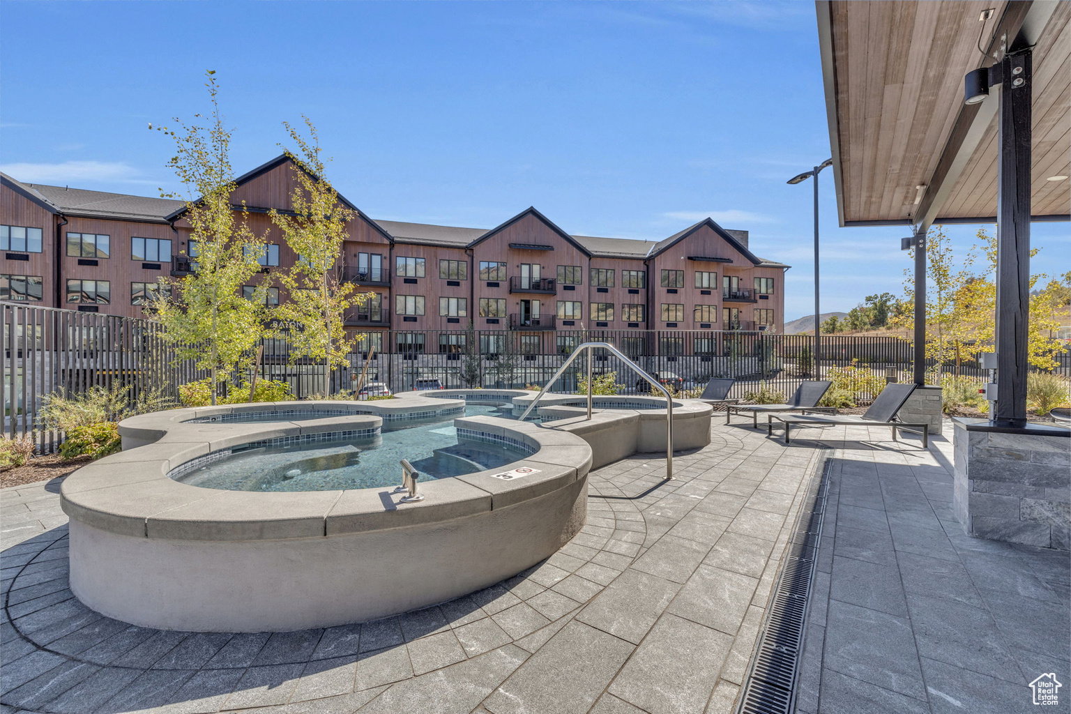 View of patio with a pool with connected hot tub