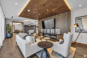 Living area with wood finished floors, wooden ceiling, and recessed lighting