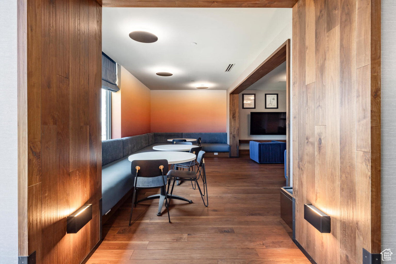 Dining area featuring dark wood-style floors