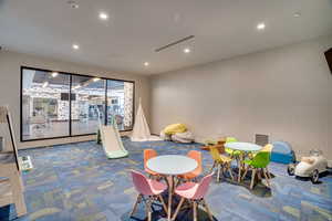 Recreation room featuring wallpapered walls and recessed lighting