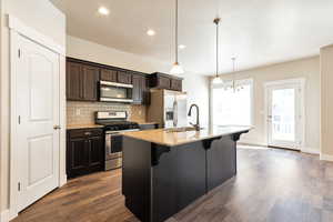 Kitchen with stainless steel appliances, a breakfast bar area