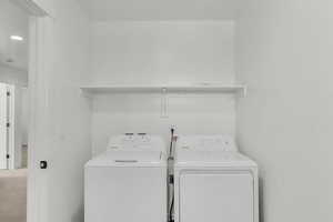 Laundry area with separate washer and dryer, carpet, and recessed lighting