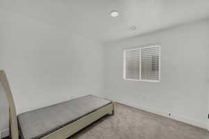 Unfurnished bedroom featuring carpet flooring and baseboards