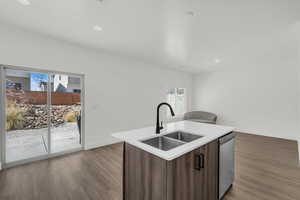 Kitchen with modern cabinets, dark wood finish cabinetry, dark wood-type flooring, stainless steel dishwasher, and recessed lighting