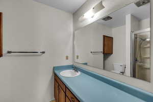 Bathroom featuring vanity and a shower stall
