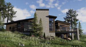 Rear view of property with a chimney and a deck
