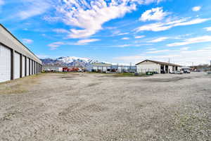 View of parking with community garages and a mountain view