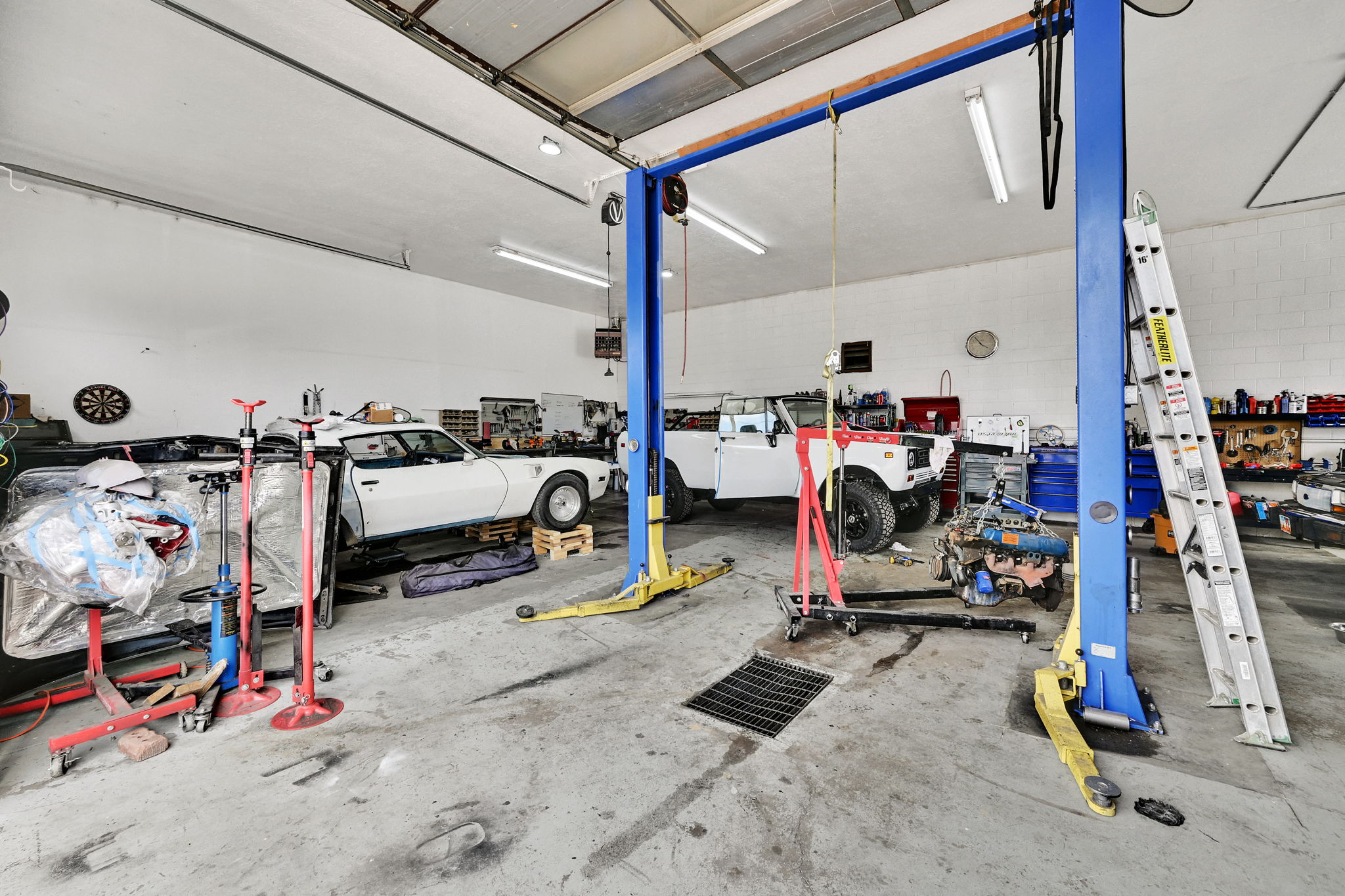 Garage featuring a heating unit and a workshop area