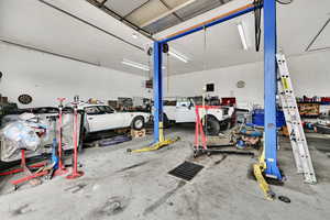 Garage featuring a heating unit and a workshop area